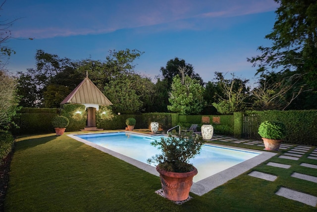 view of swimming pool with fence, a lawn, and a fenced in pool