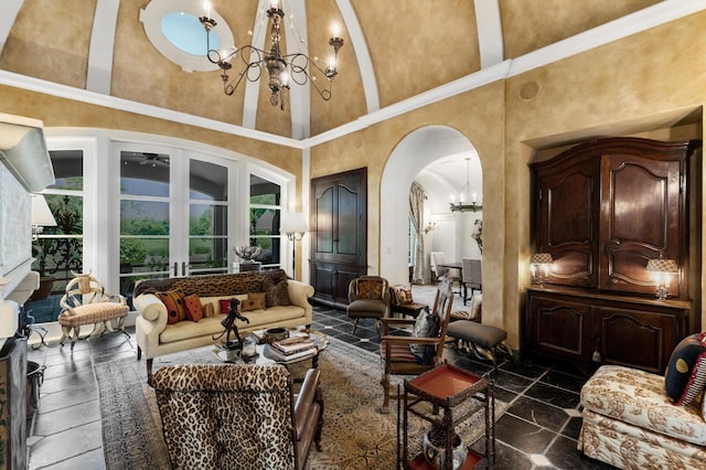 living room with french doors, arched walkways, a high ceiling, and a chandelier