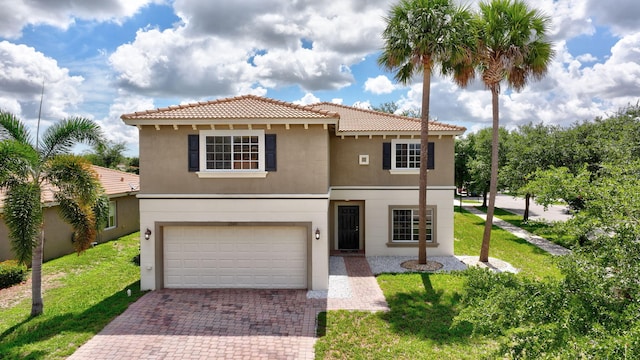 view of front of property featuring decorative driveway, a garage, a front lawn, and stucco siding