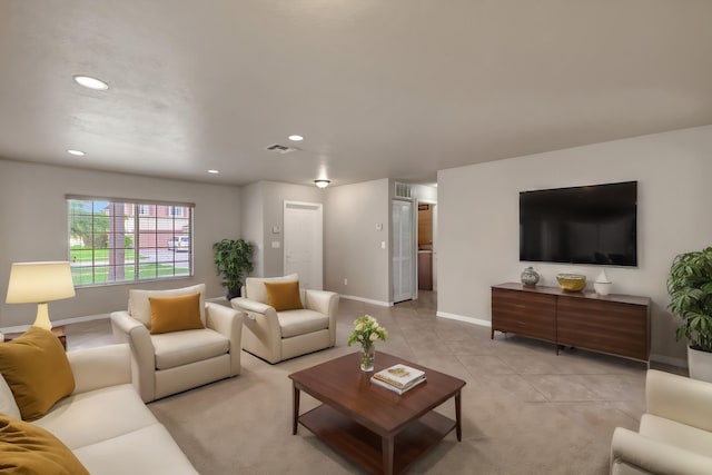 living room with light tile patterned flooring, visible vents, recessed lighting, and baseboards