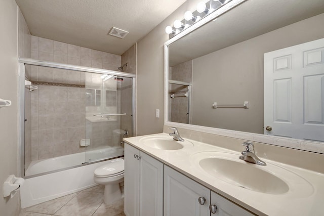 full bathroom featuring enclosed tub / shower combo, visible vents, toilet, and a sink