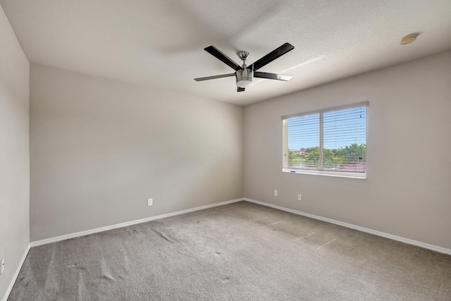 carpeted empty room with baseboards, a textured ceiling, and ceiling fan