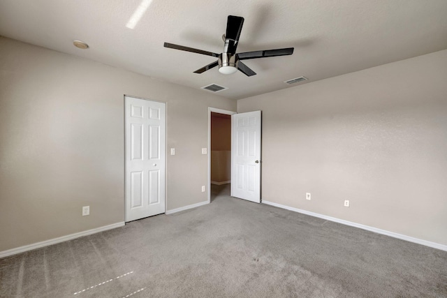 unfurnished bedroom featuring visible vents, carpet floors, and baseboards