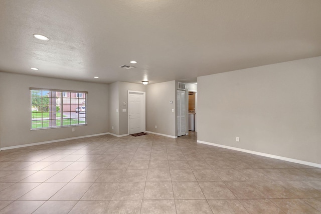 unfurnished room with light tile patterned floors, baseboards, a textured ceiling, and recessed lighting