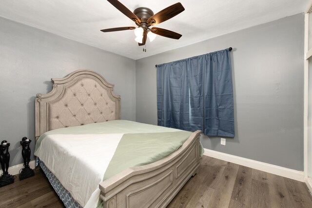 bedroom featuring ceiling fan and dark hardwood / wood-style floors