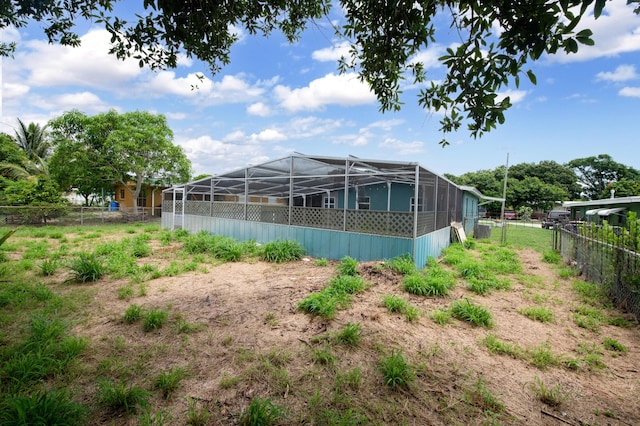 view of yard with glass enclosure