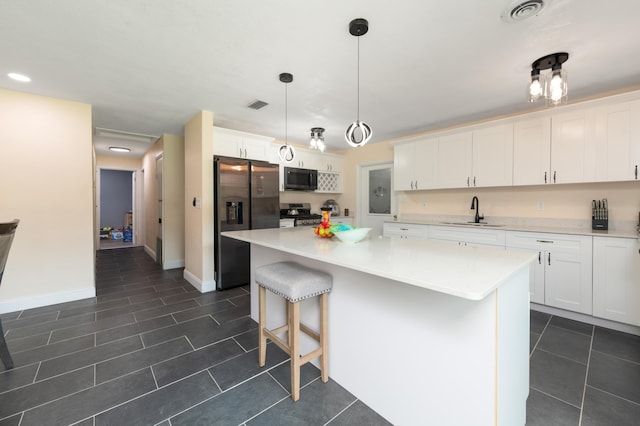 1013 Hispana Ave, Fort Pierce, FL 34982 - kitchen featuring appliances with stainless steel finishes, a sink, white cabinets, and recessed lighting