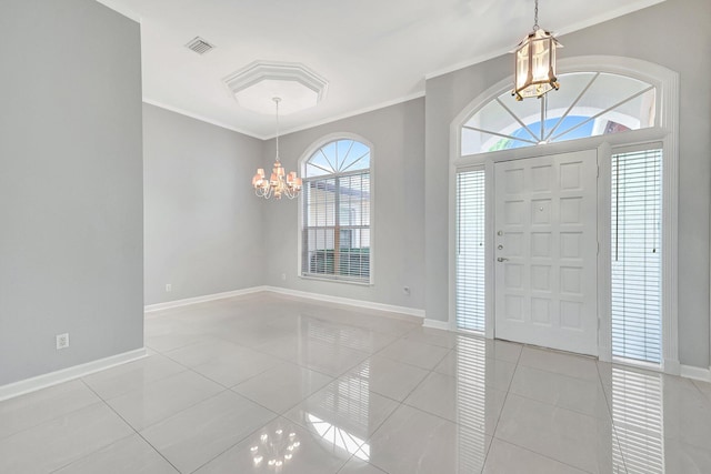 foyer entrance featuring crown molding, light tile patterned floors, and a notable chandelier