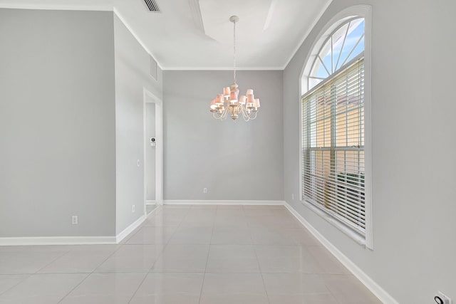 empty room with a notable chandelier, tile patterned floors, and crown molding