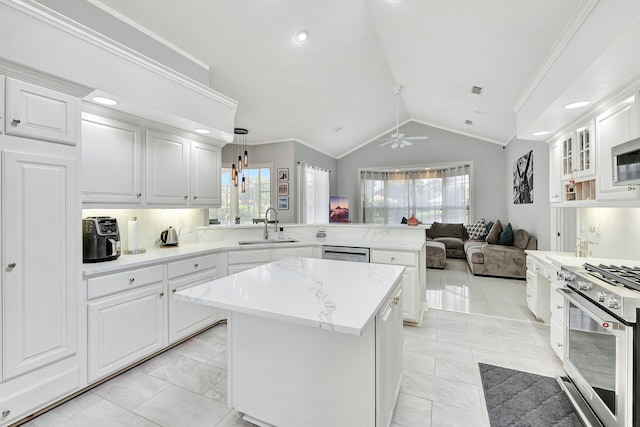 kitchen featuring ceiling fan, tasteful backsplash, stainless steel appliances, crown molding, and light tile patterned floors