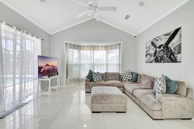 tiled living room with ceiling fan, vaulted ceiling, and a healthy amount of sunlight