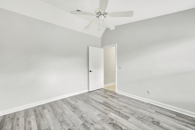 empty room featuring vaulted ceiling, ceiling fan, and light hardwood / wood-style floors