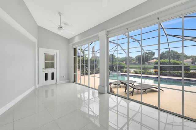 unfurnished sunroom featuring ceiling fan and vaulted ceiling