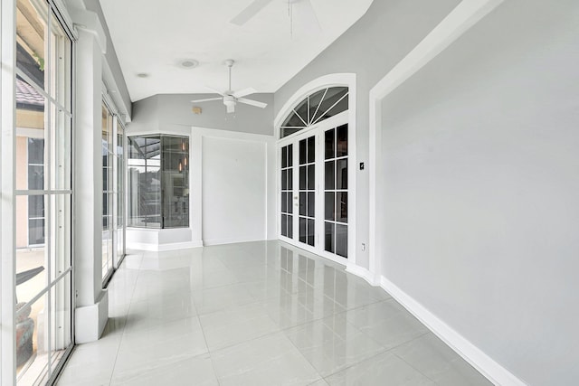 unfurnished sunroom with lofted ceiling and ceiling fan