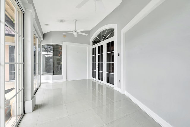 unfurnished sunroom featuring a wealth of natural light, ceiling fan, and vaulted ceiling