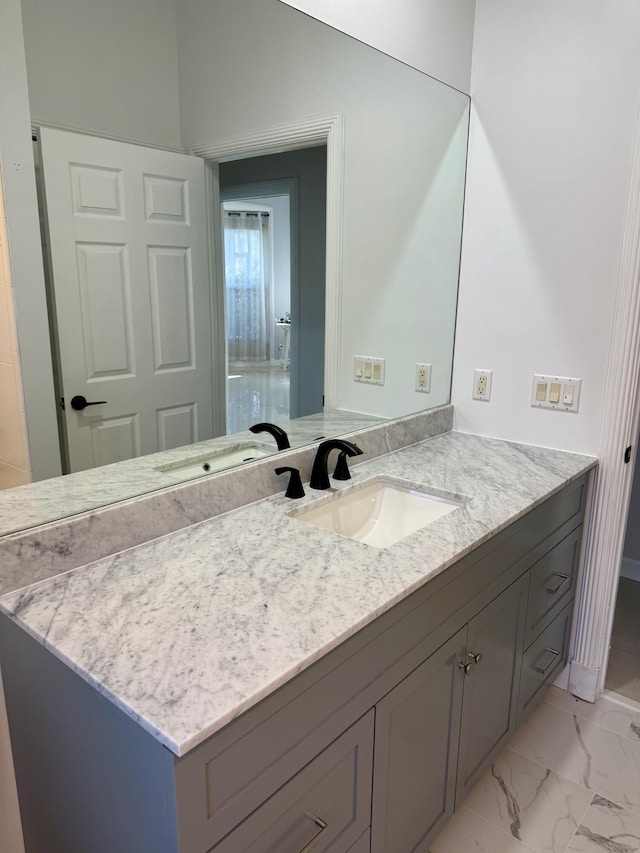 bathroom featuring vanity and marble finish floor
