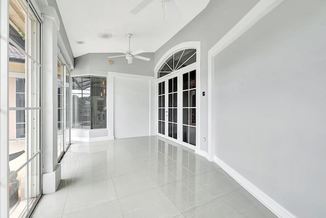 interior space featuring baseboards, lofted ceiling, and tile patterned floors