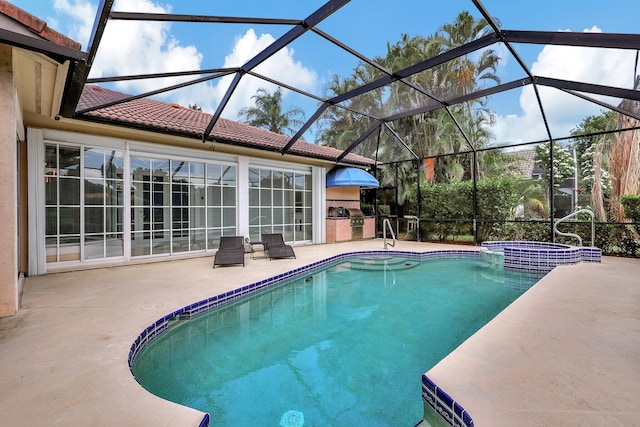 view of swimming pool featuring area for grilling, a pool with connected hot tub, a patio area, and glass enclosure