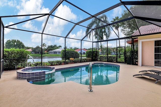view of pool featuring glass enclosure, a water view, a pool with connected hot tub, and a patio area