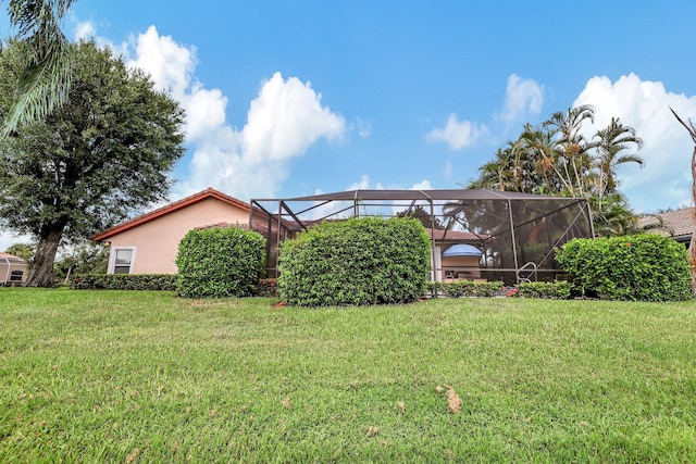 view of yard with glass enclosure