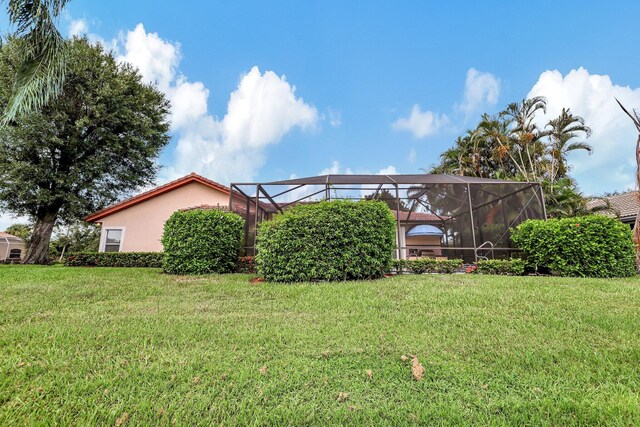 view of yard featuring glass enclosure