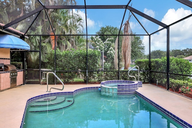view of pool with grilling area, glass enclosure, a pool with connected hot tub, and exterior kitchen