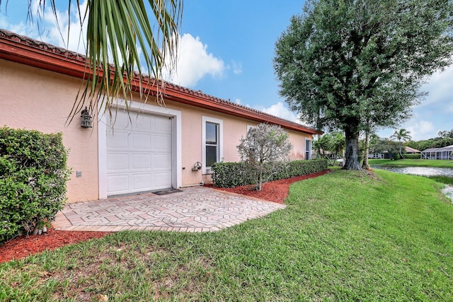 exterior space with a garage and a front yard