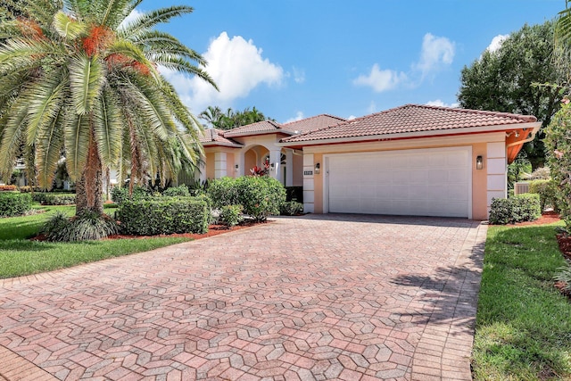 mediterranean / spanish house with a garage