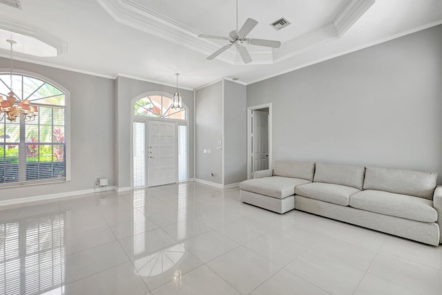 unfurnished living room with crown molding, light tile patterned floors, a tray ceiling, and ceiling fan with notable chandelier