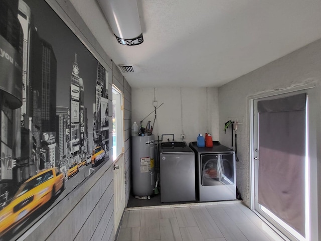 laundry room featuring washer and clothes dryer and water heater