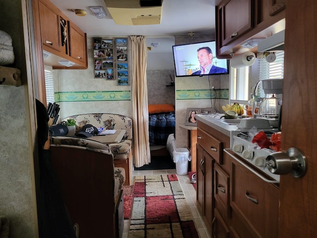 kitchen featuring light tile patterned floors and sink