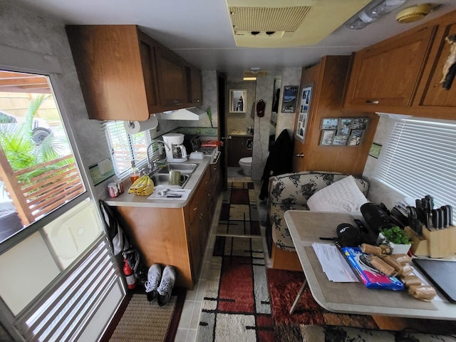 kitchen featuring sink and dark tile patterned floors