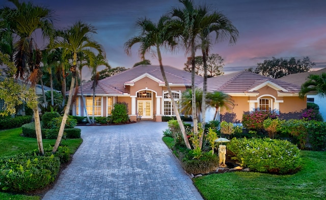 ranch-style home with a lawn and french doors