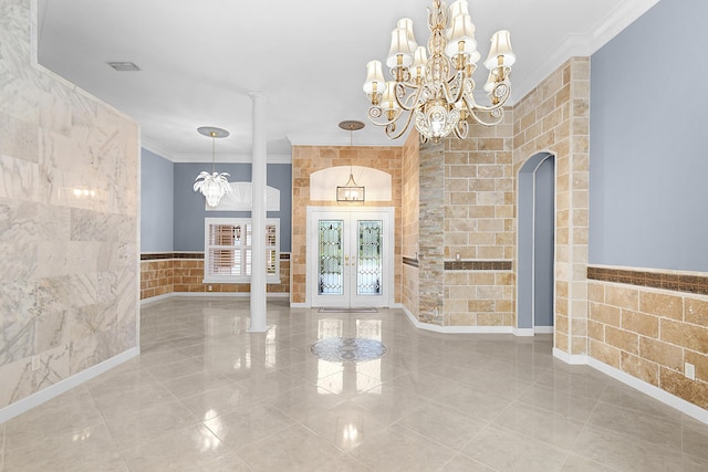 entryway featuring ornamental molding, tile walls, and french doors