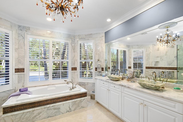 bathroom featuring an inviting chandelier, a wealth of natural light, and tile walls