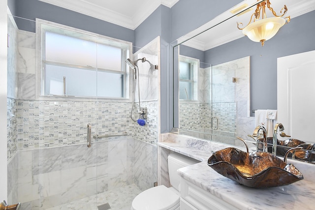 bathroom with vanity, toilet, a shower with shower door, and crown molding