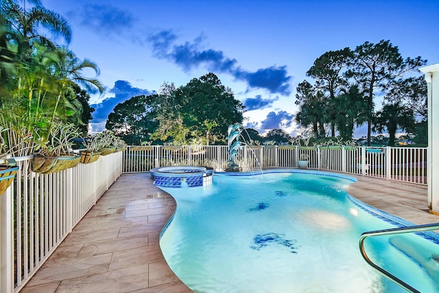 view of swimming pool featuring an in ground hot tub and a patio