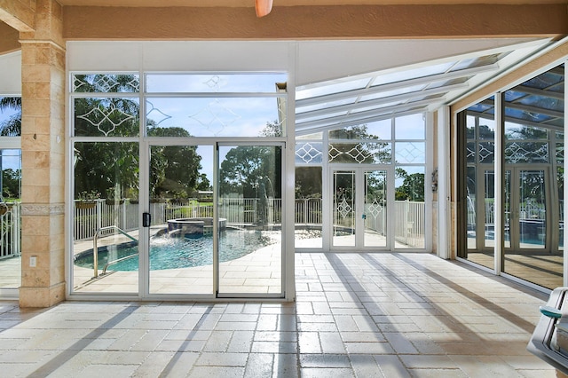 unfurnished sunroom with lofted ceiling