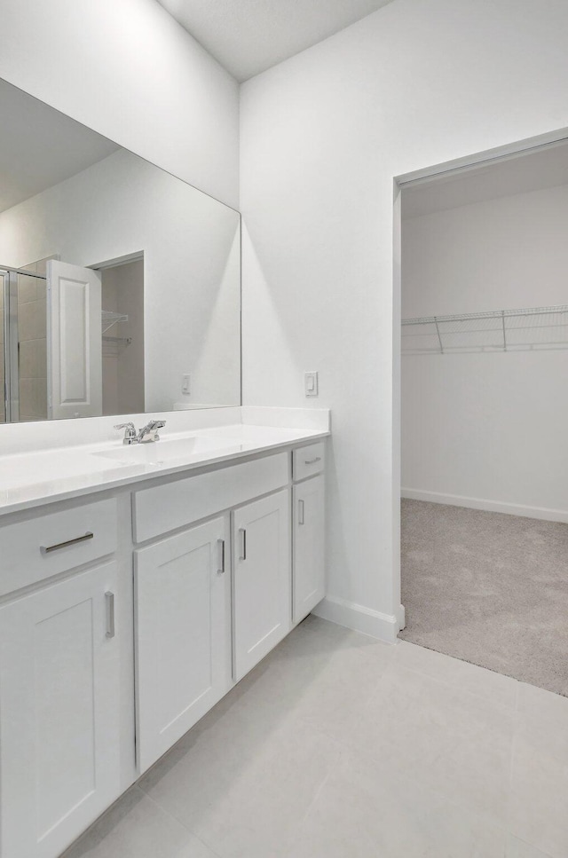 bathroom with vanity and a shower with shower door