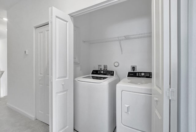 washroom with washing machine and clothes dryer