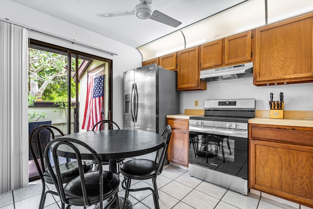 kitchen featuring electric stove, ceiling fan, and light tile floors