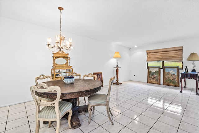 tiled dining area featuring a textured ceiling and a chandelier