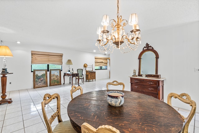 tiled dining space with an inviting chandelier and a textured ceiling