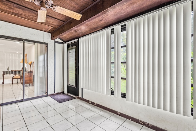 unfurnished sunroom featuring beamed ceiling, wooden ceiling, and ceiling fan