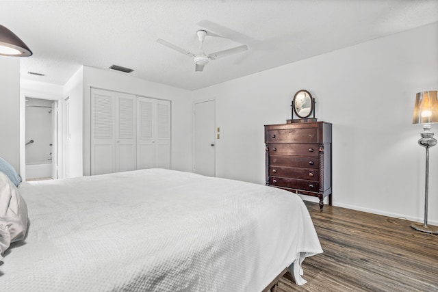 bedroom with a closet, ceiling fan, and dark hardwood / wood-style flooring