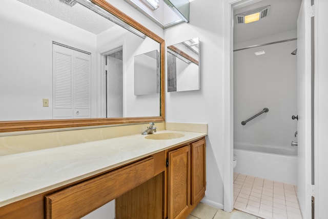 full bathroom with tile floors, washtub / shower combination, vanity, and toilet