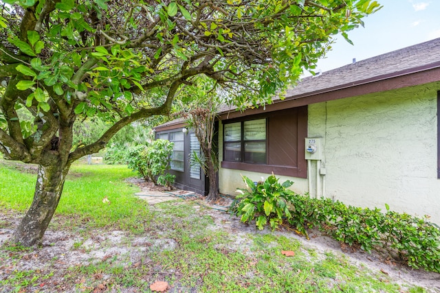 view of side of home featuring a lawn