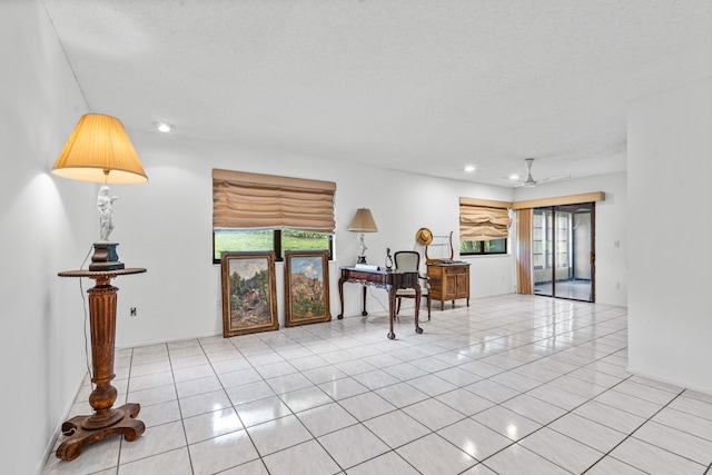 living room with a textured ceiling and light tile flooring