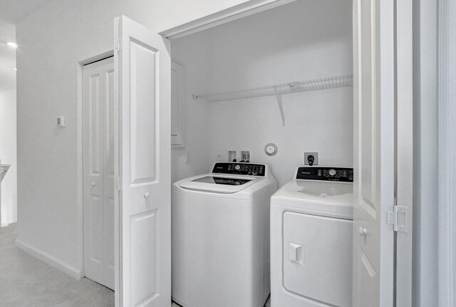 laundry room with washing machine and clothes dryer