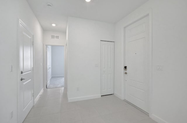 hall with light tile patterned floors